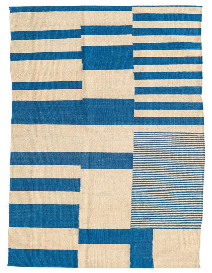 An 8 ft runner rug with a modern tribal pattern in ivory and blue, featuring bold stripes and abstract blocks.