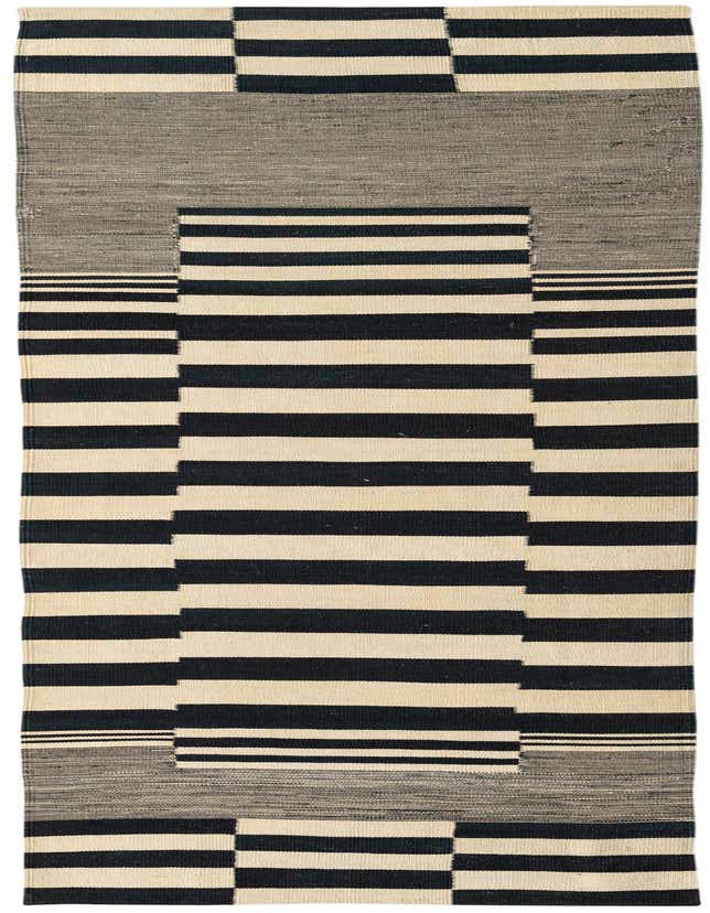 A 10 Ft runner rug from the Kilim Modern collection, featuring a tribal abstract pattern with black and ivory stripes and solid blocks.