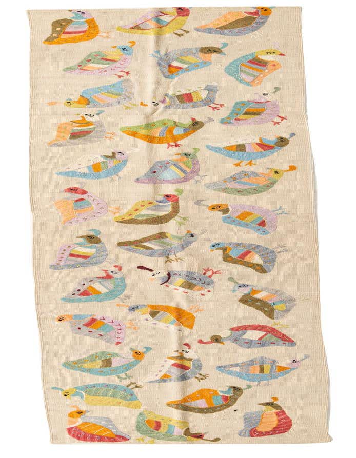 A 9 ft Kilim Suzani runner rug in ivory with colorful, embroidered tribal bird patterns, ideal for a hallway.
