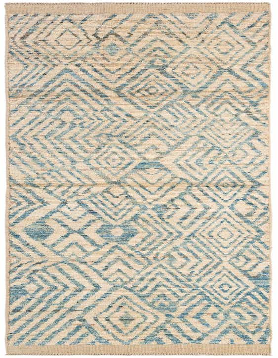 A 10 ft runner rug with an ivory background and a blue tribal geometric pattern, perfect for a hallway.