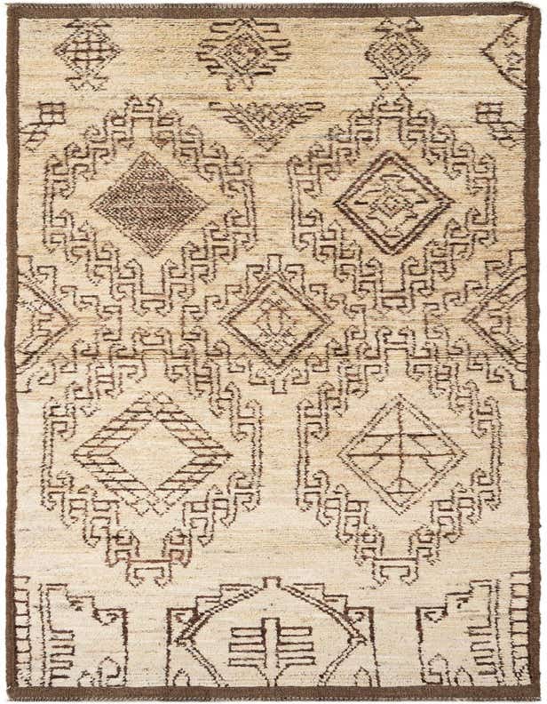 A 10 Ft Runner Moroccan rug in ivory and brown, featuring tribal geometric patterns and a medium pile.