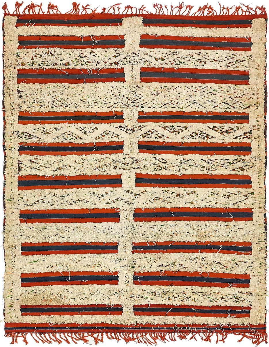 A 10 Ft Runner Moroccan rug with a shag pile, featuring ivory, red, and navy blue stripes and tribal patterns.
