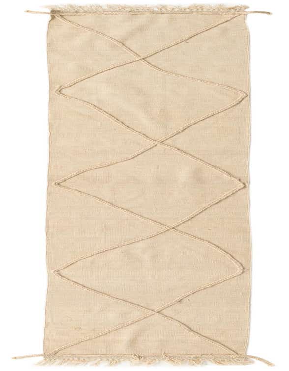 A 10 ft ivory wool runner rug with a raised geometric diamond pattern and fringed ends, perfect for a hallway.
