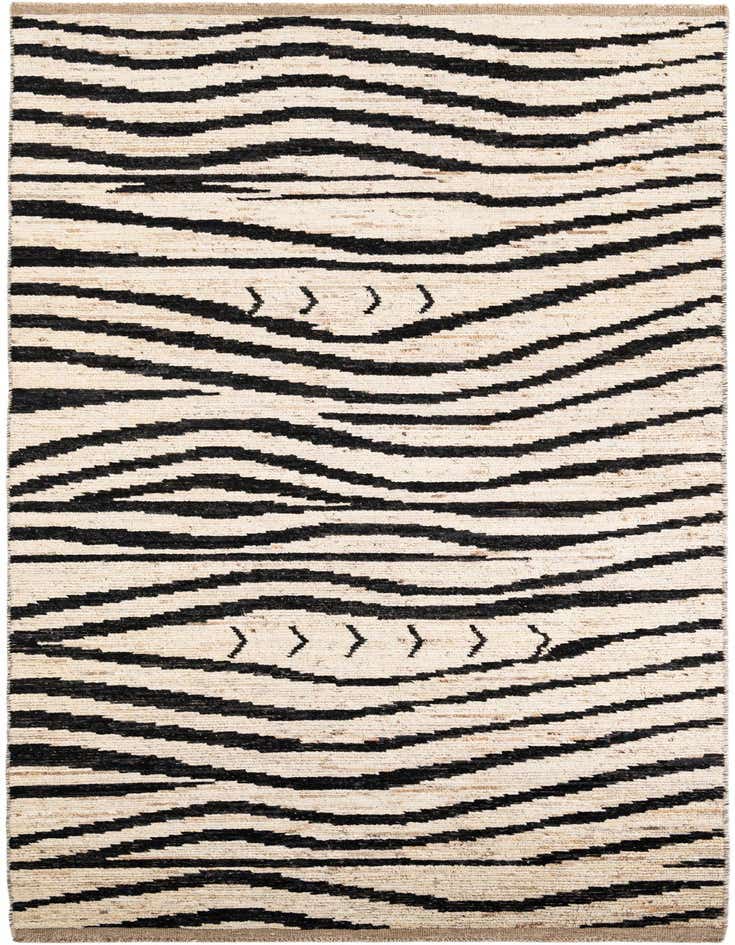 A 14 ft runner rug with a tribal, abstract pattern of thick black wavy stripes and arrow-like motifs on an ivory background.