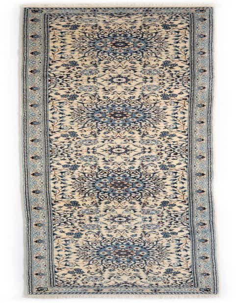 A 12 ft handmade wool runner rug in ivory and blue with an intricate Persian floral pattern, ideal for hallways.