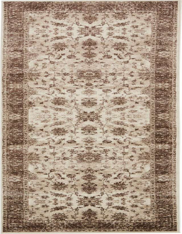 A 10 ft runner rug in ivory and cream with a traditional floral pattern and a distressed brown border, ideal for a hallway.