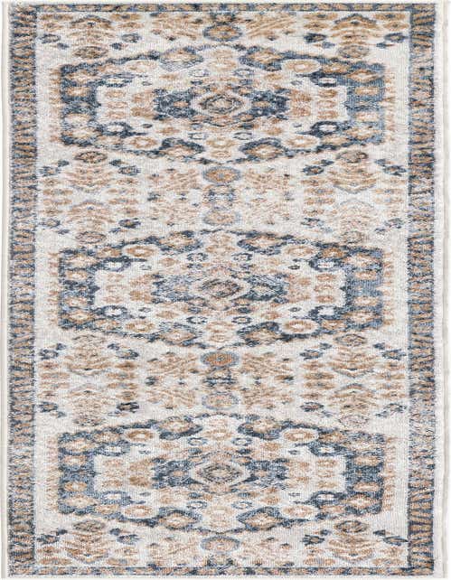 An 8 ft runner rug with a distressed Bohemian medallion pattern in ivory, cream, blue, and brown, ideal for a hallway or kitchen.