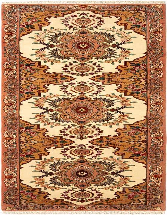 A 10 ft handmade Persian runner rug in ivory and cream with intricate floral patterns in peach, gold, and green, ideal for a hallway.