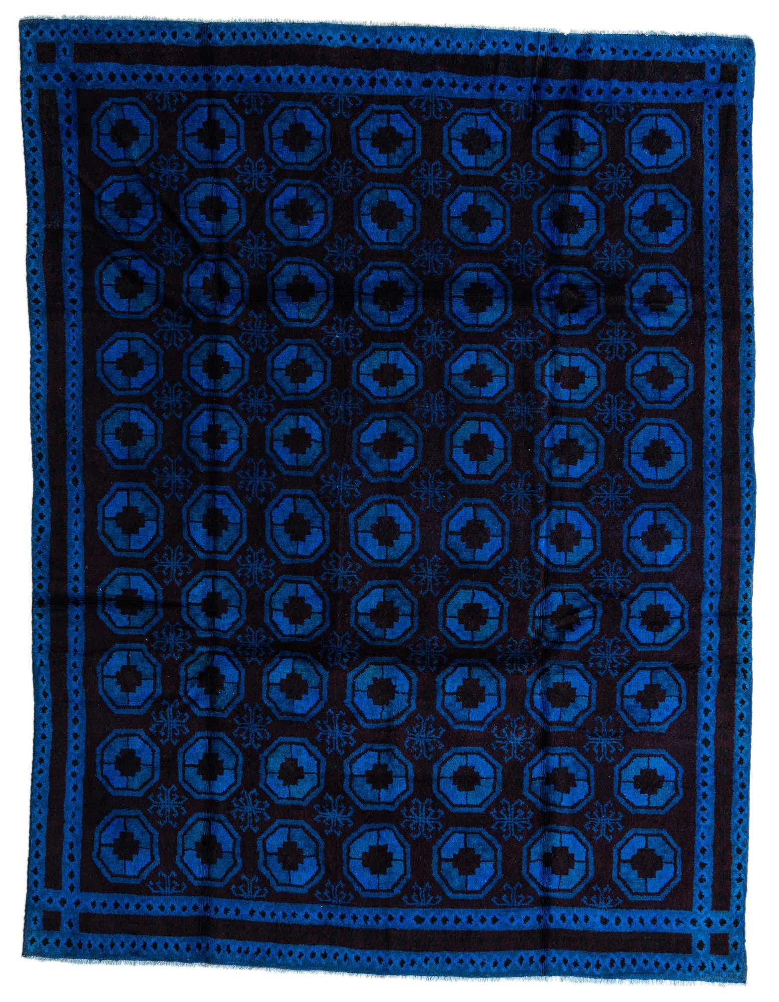 An 8x10 rectangular Balouch rug in deep blues with a tribal, modern pattern and a thin pile.