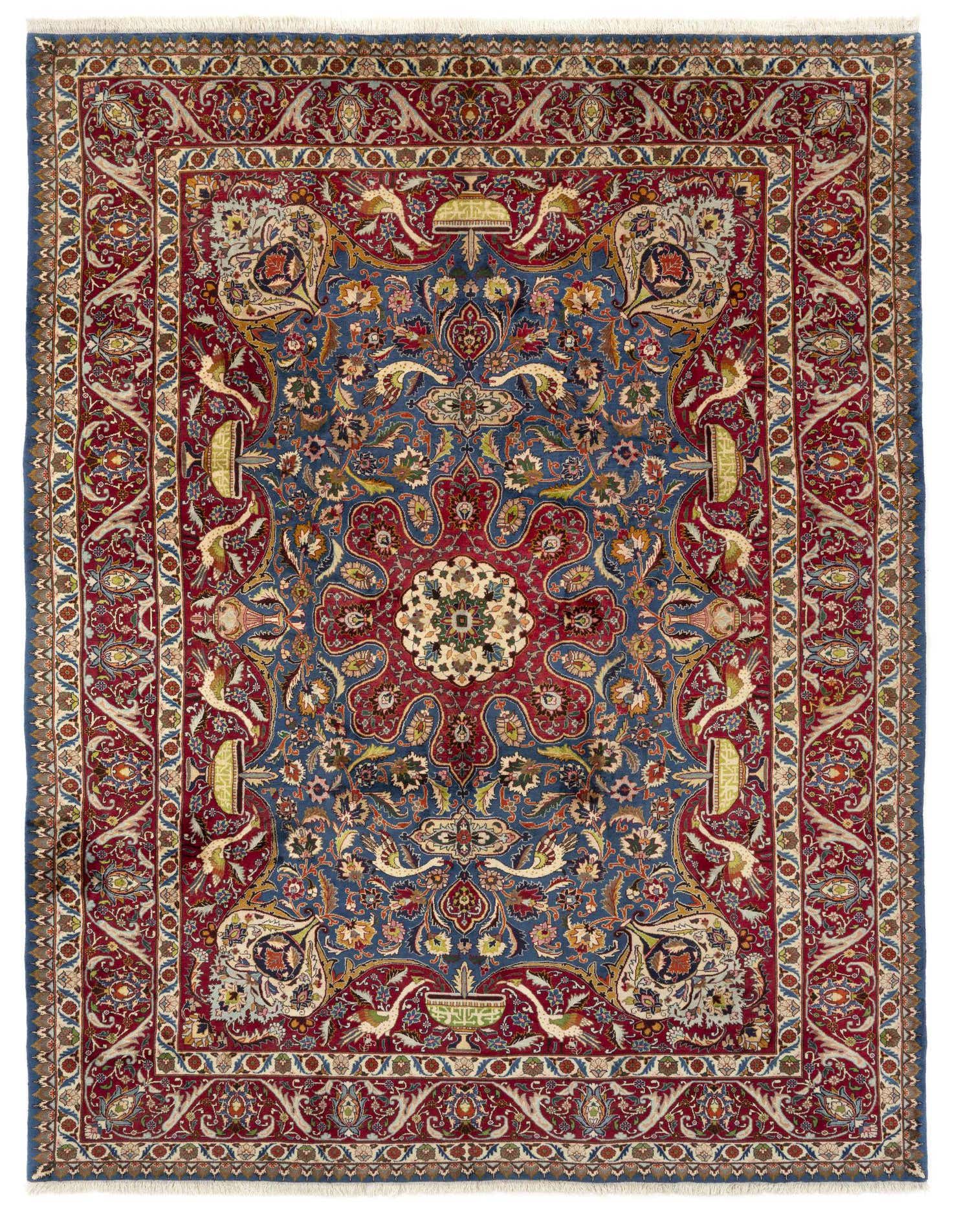 A large 10x13 rectangular Persian Kashmar rug with a deep blue field, intricate floral motifs, and a rich red border.
