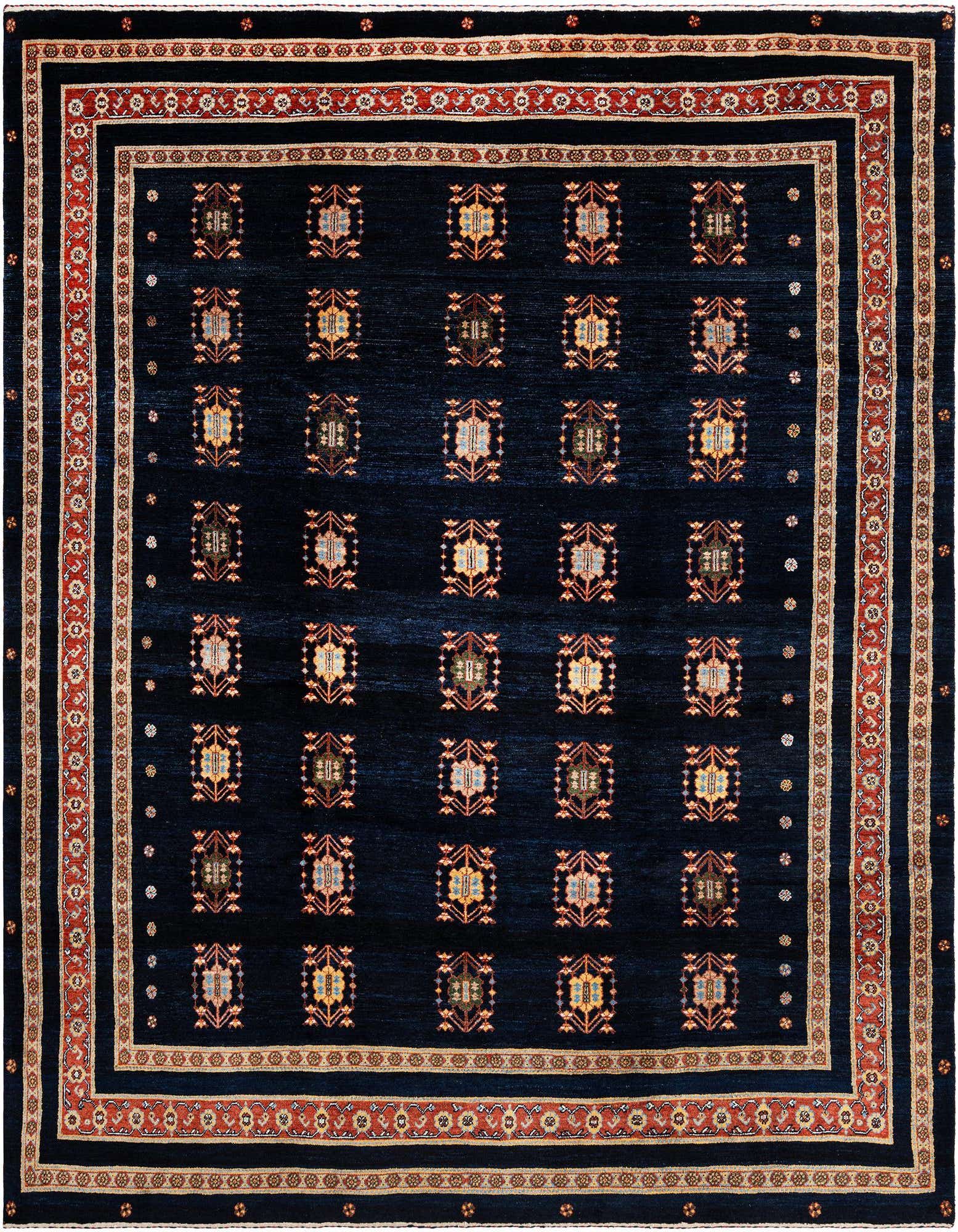 A handmade rectangular Luribaft Persian rug with a deep blue field and intricate geometric motifs, framed by a multi-layered border in red, gold, and cream.