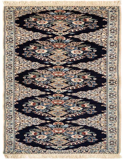 A handmade rectangular Persian runner rug with a deep blue background and intricate floral patterns in cream, light blue, and muted red, featuring cream fringe.