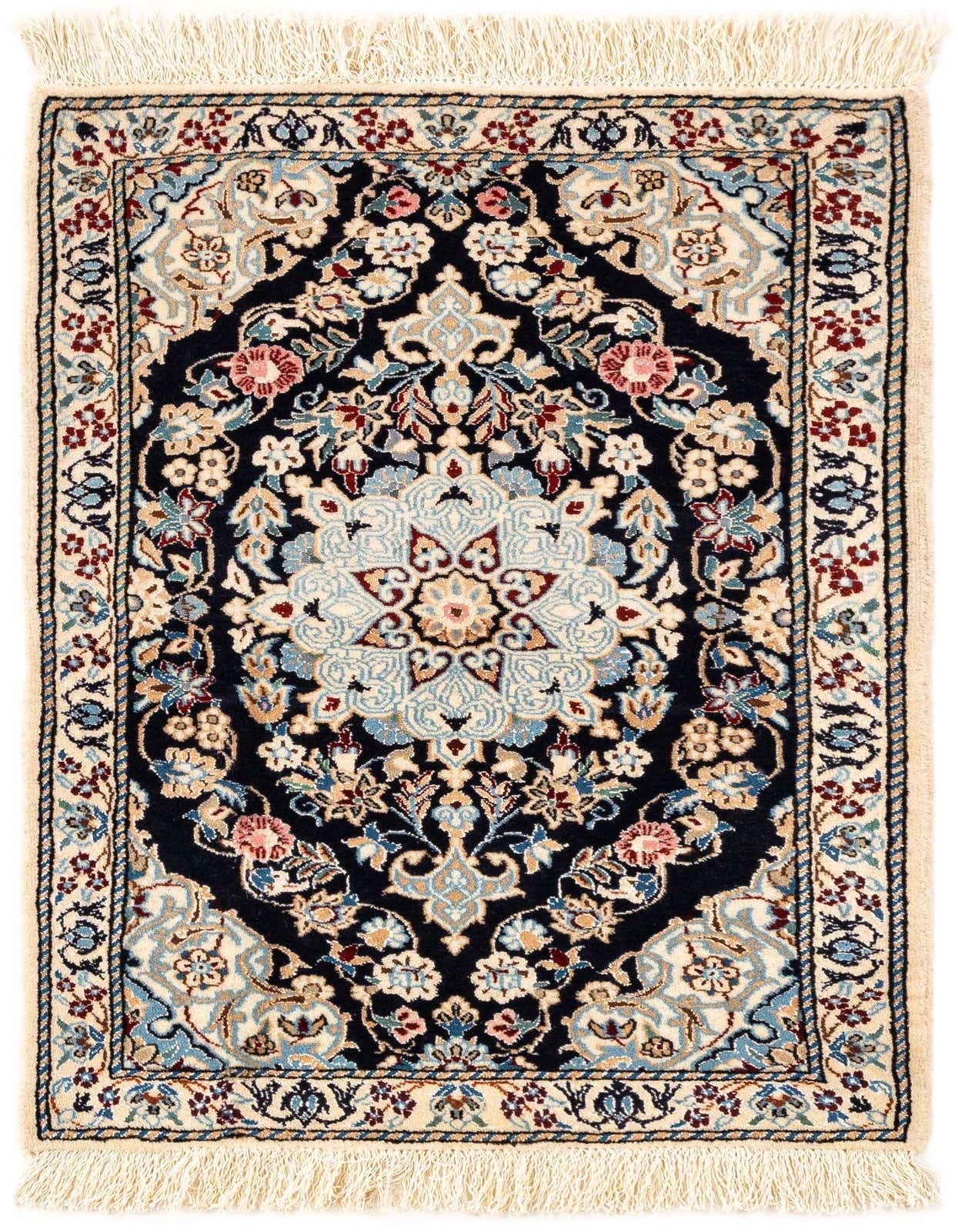 A rectangular handmade Persian rug with a dark navy background and intricate floral patterns in blues, creams, and reds, featuring cream fringes.