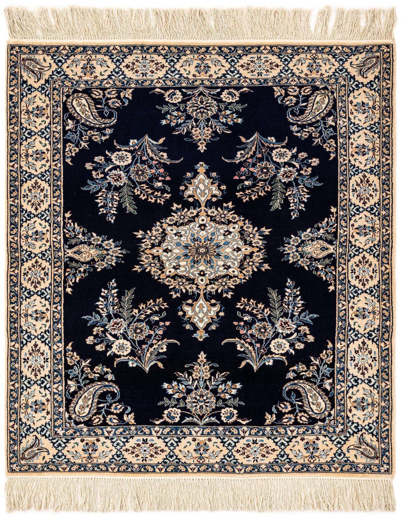 Handmade rectangular Persian rug with a deep blue field, intricate floral motifs, and a cream border with fringe.