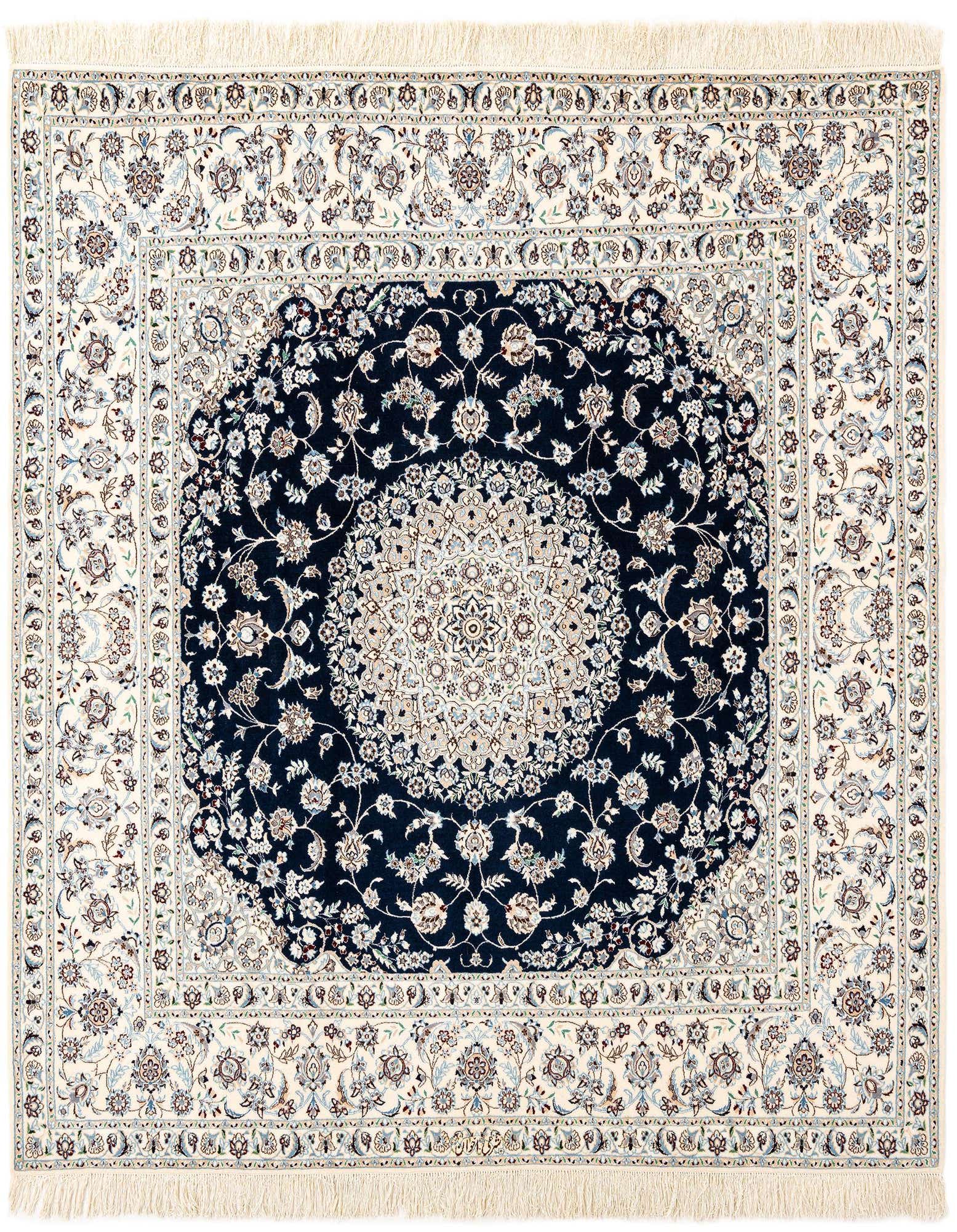 A handmade rectangular Persian rug featuring a detailed floral medallion in navy blue and cream with a matching border.