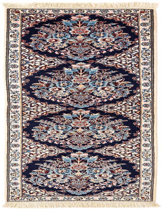 A handmade rectangular Persian rug from the Nain collection, featuring a deep blue field with intricate floral and medallion patterns in shades of light blue, pink, and cream, bordered by a cream frame with delicate motifs, and finished with cream fringes.