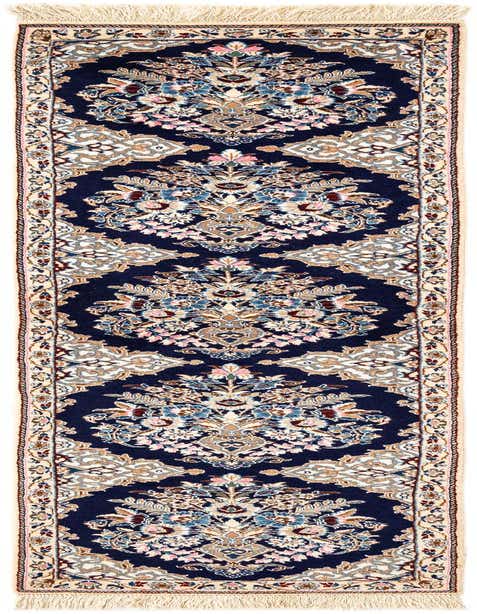 A handmade rectangular Nain Persian rug featuring a rich navy blue background with intricate floral patterns in cream, light blue, pink, and brown, bordered by a cream frame.