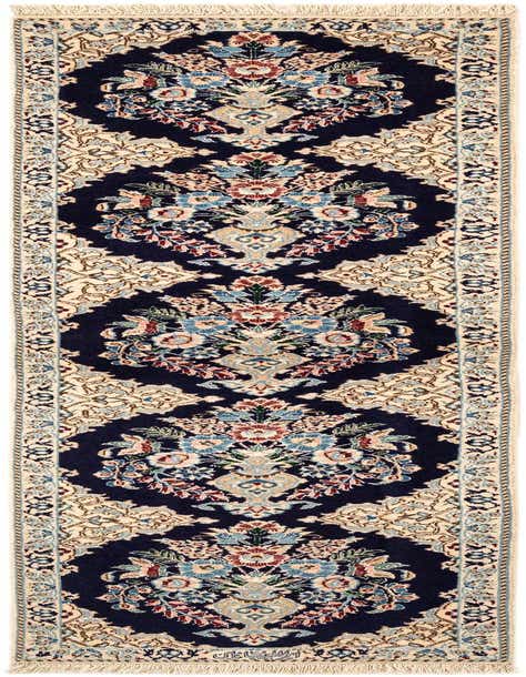 A rectangular handmade Persian rug featuring a navy blue background with intricate floral and medallion patterns in shades of blue, red, and cream.