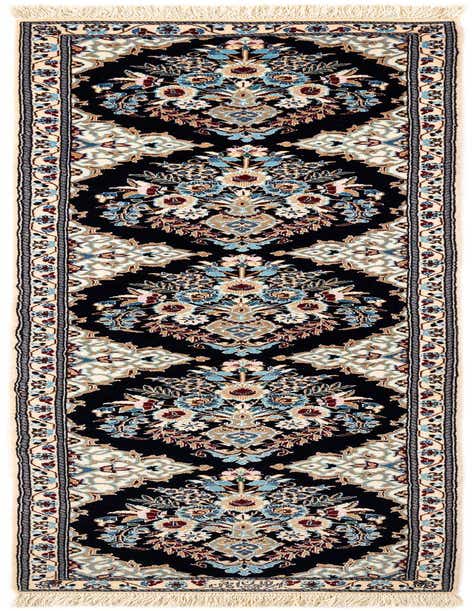 A handmade rectangular Persian runner rug featuring an intricate floral medallion pattern in blues, creams, and reds on a dark navy background, with cream fringe.