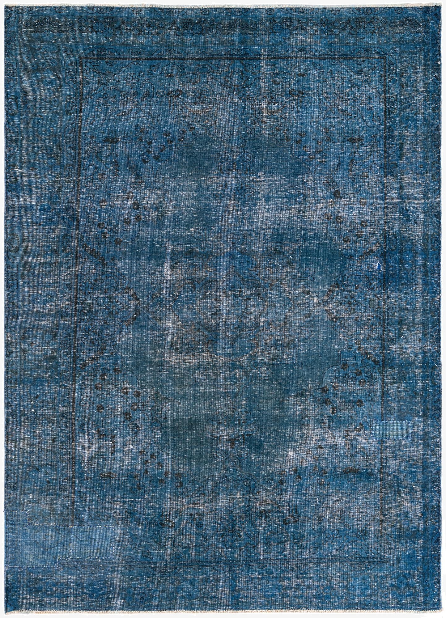 A 7x10 rectangular blue wool rug with a distressed Persian medallion pattern and a flat pile, perfect for a living room.