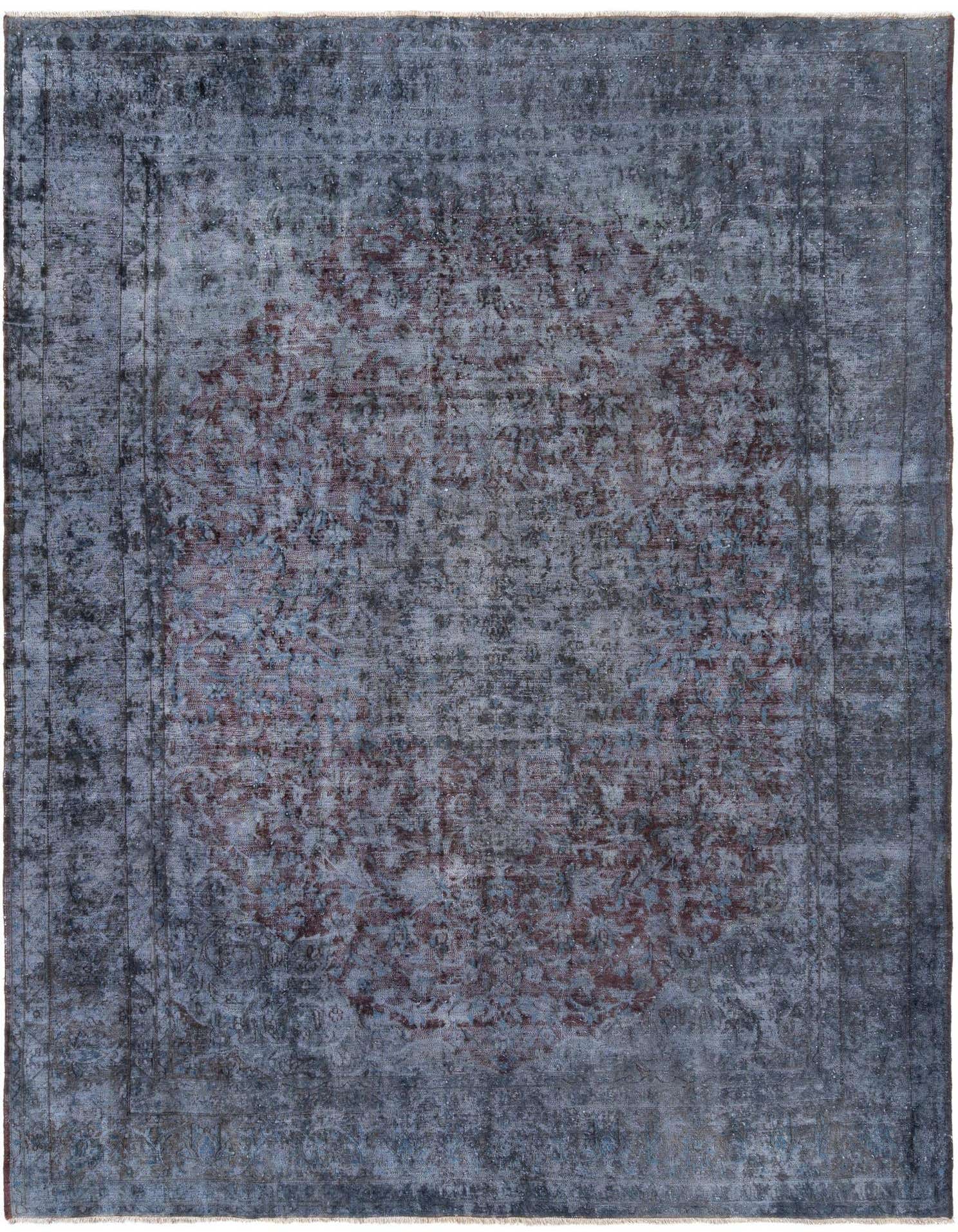 A 10x13 rectangular blue Persian rug with a faded, distressed floral medallion pattern in shades of blue and hints of red.