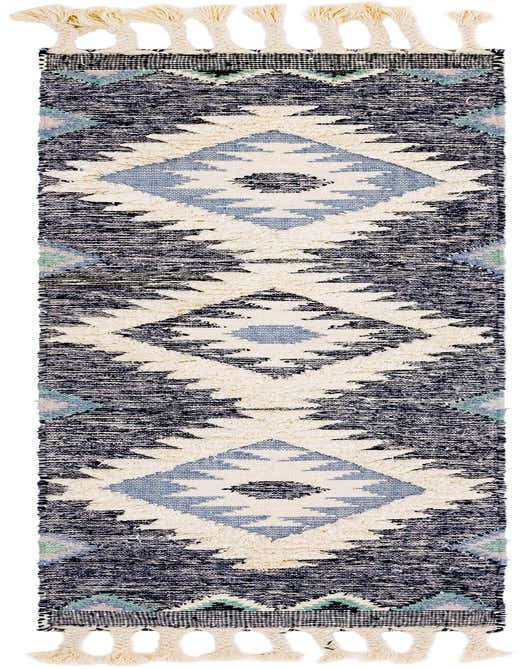 An 8 ft runner rug with a tribal bohemian pattern in shades of blue, cream, and black, featuring a textured shag pile and braided tassels.