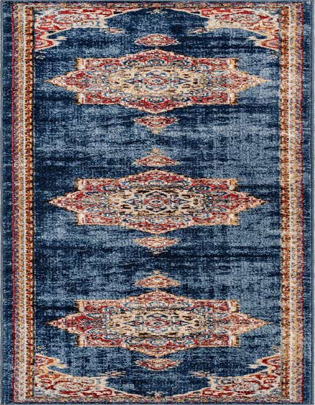 A 12 ft runner rug in shades of blue with a distressed bohemian medallion pattern and red, beige, and gold accents.