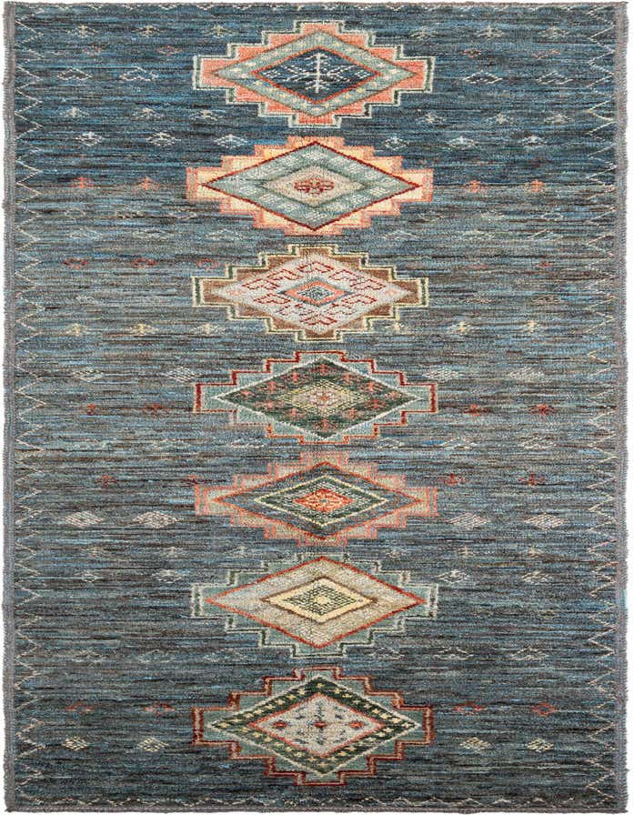 A 14 ft blue wool runner rug with a tribal medallion pattern in shades of blue, orange, green, and cream, perfect for a hallway.