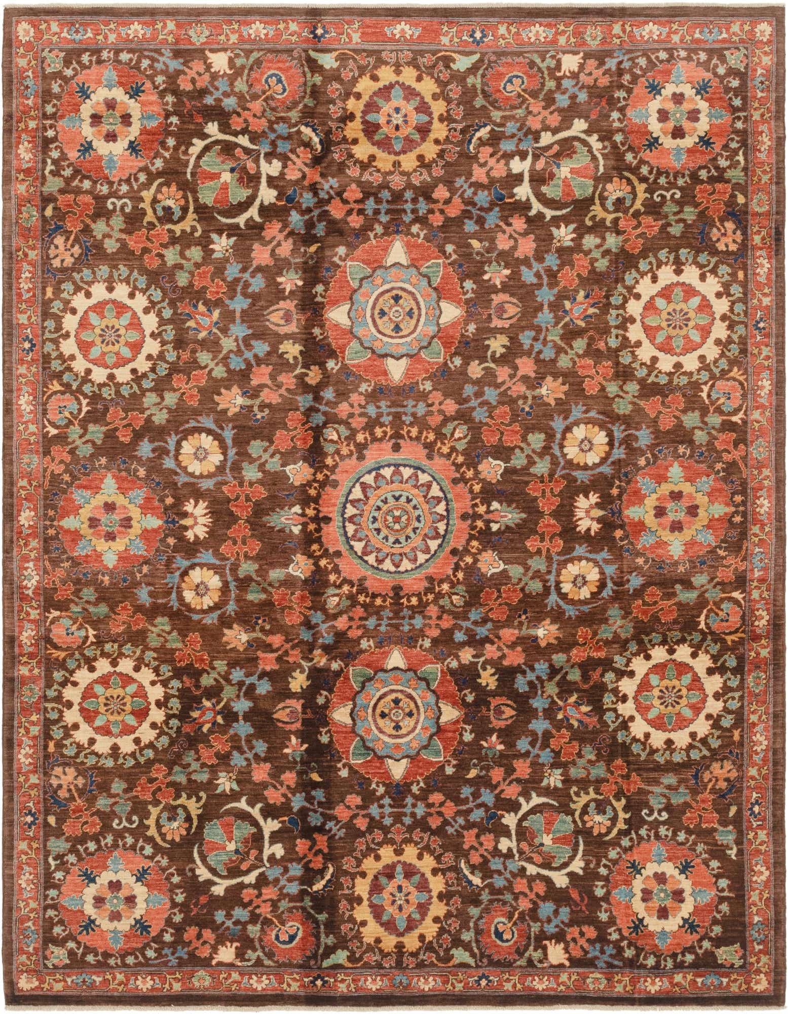 A 6x9 rectangular Ariana Ziegler rug featuring a rich brown background with intricate traditional tribal patterns in tan, rust, blue, and green.