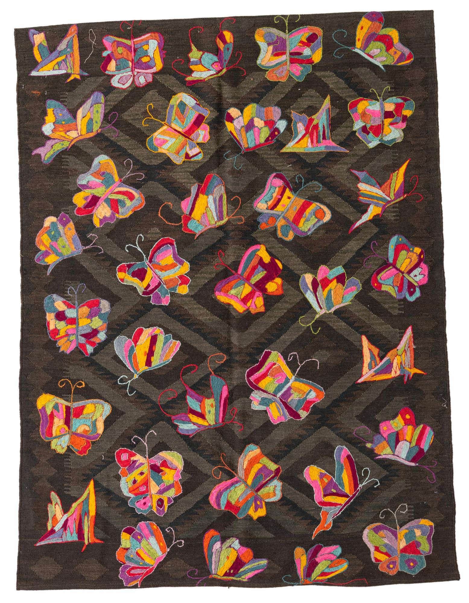A 4x6 rectangular flatweave rug featuring a dark brown tribal pattern background with colorful embroidered butterflies in various sizes and hues.