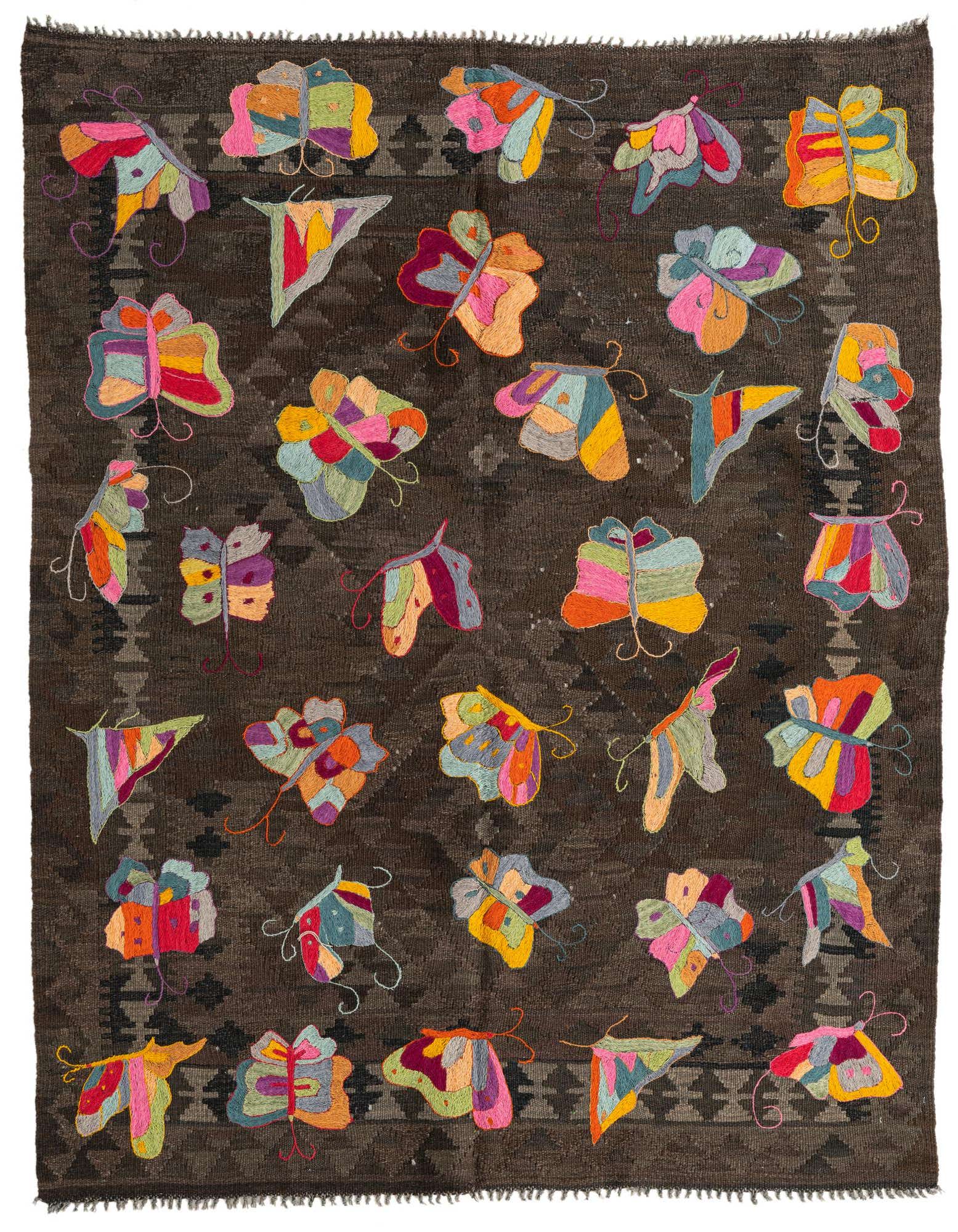 A 5x8 rectangular brown Kilim Suzani rug with colorful embroidered butterflies and subtle tribal patterns.