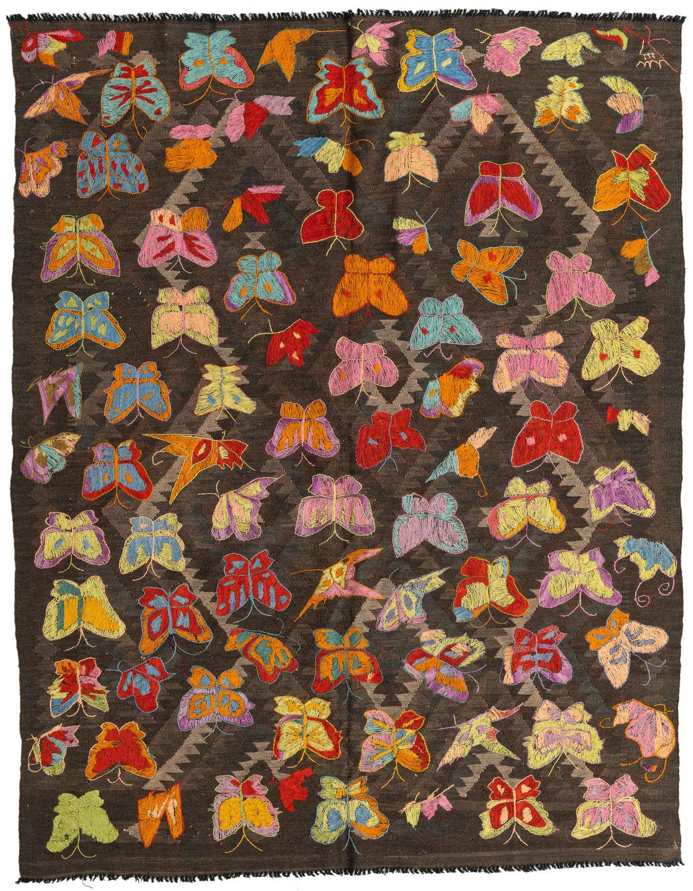 A 5x8 rectangular Kilim Suzani rug featuring a dark brown background with colorful embroidered butterflies in various hues like red, blue, yellow, and pink, over a subtle tan tribal pattern.