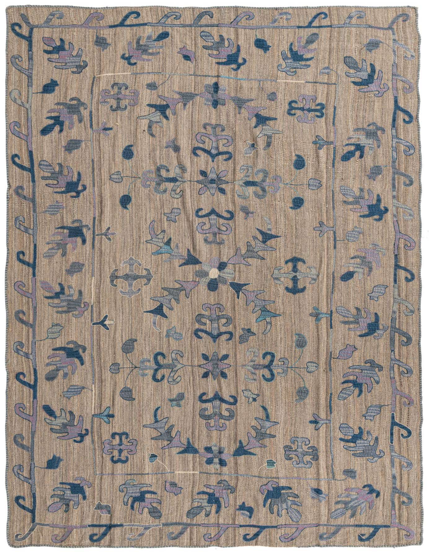 A 6x9 rectangular Kilim Suzani rug featuring a tribal oriental pattern in shades of gray, silver, and muted blues on a flatweave wool texture.