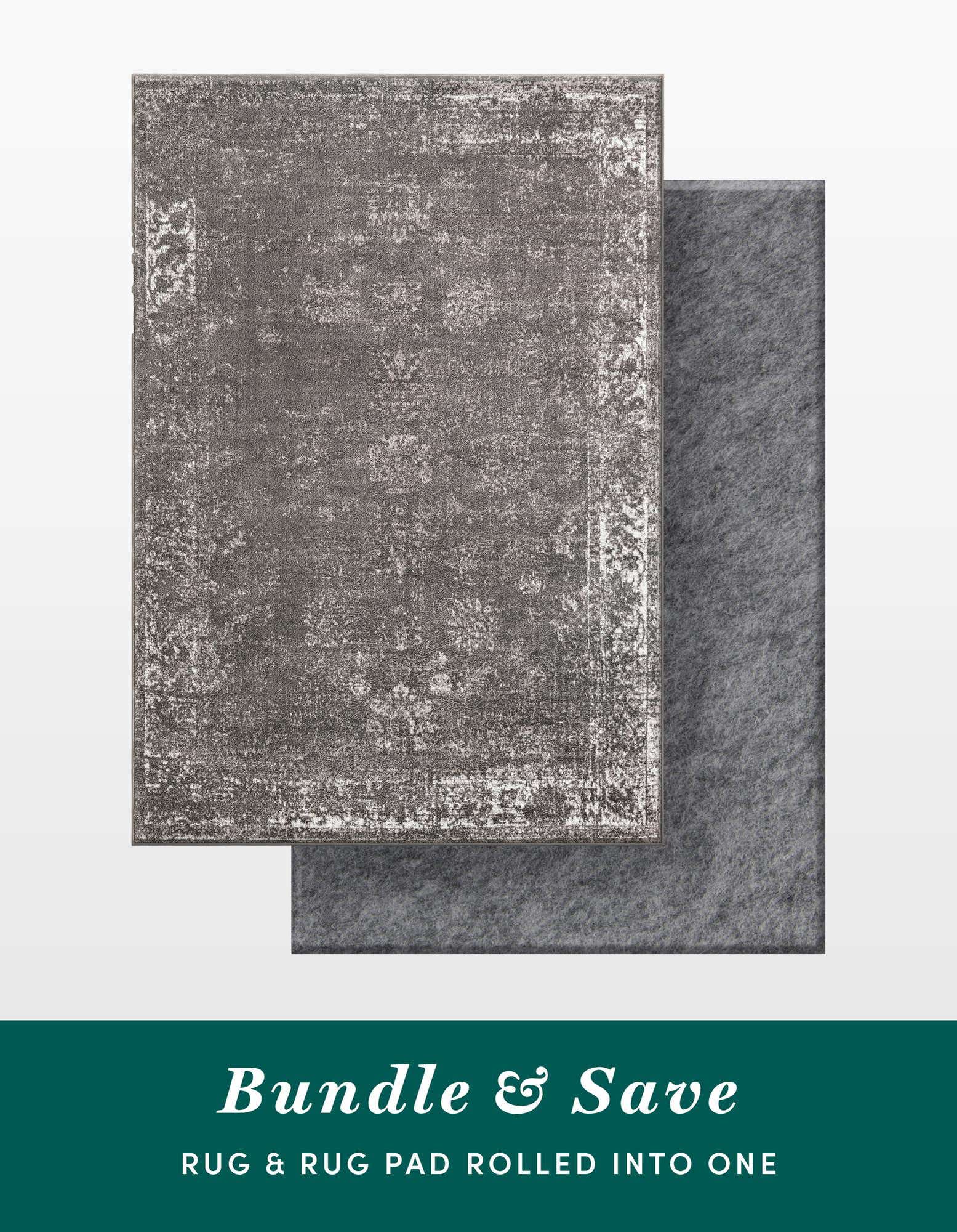 A 6x9 rectangular gray vintage-style rug with a distressed traditional pattern, shown with a gray rug pad underneath.