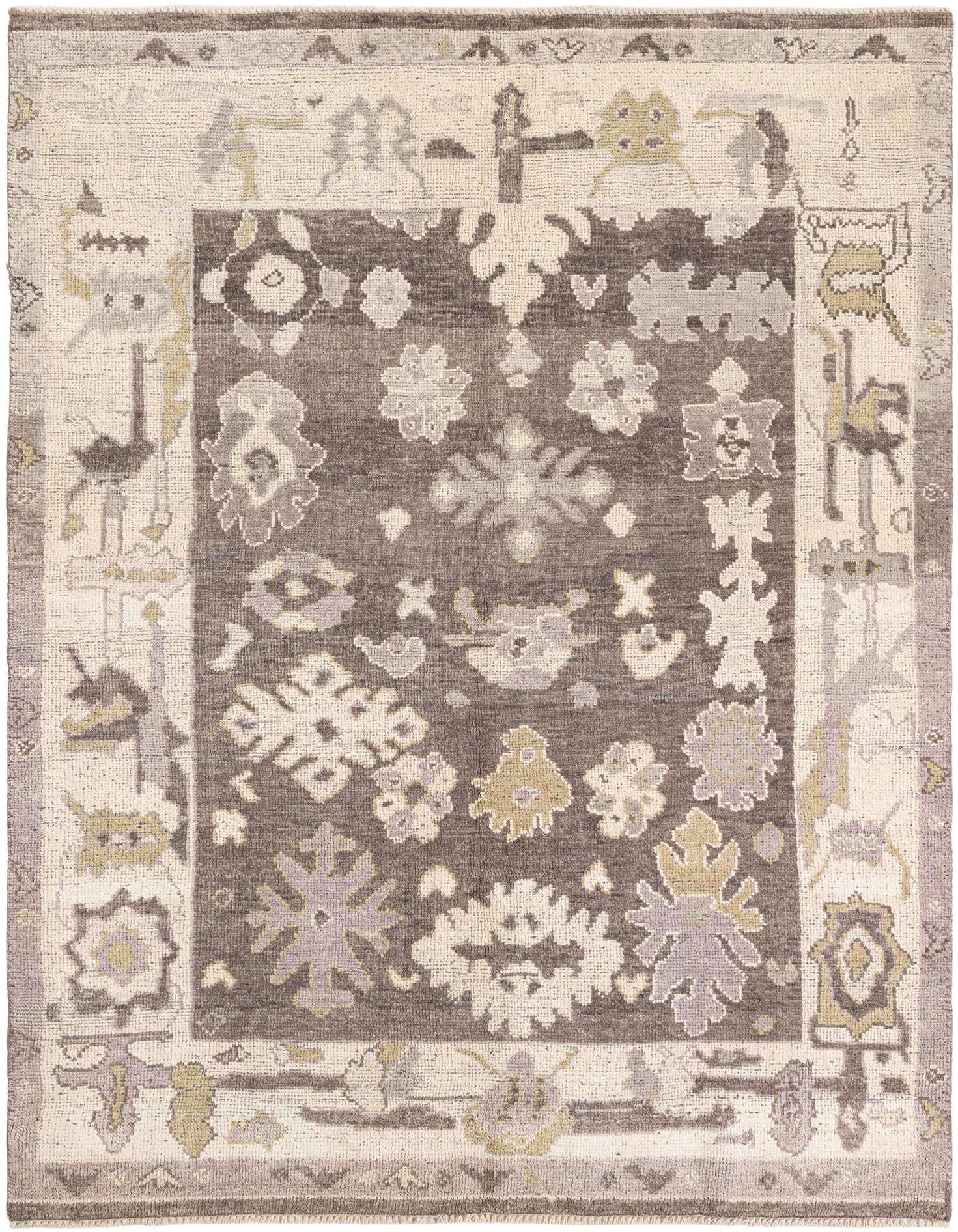 A 5x8 rectangular gray wool shag rug with a tribal, modern, and oriental pattern, featuring light gray, silver, and beige motifs on a darker gray field.