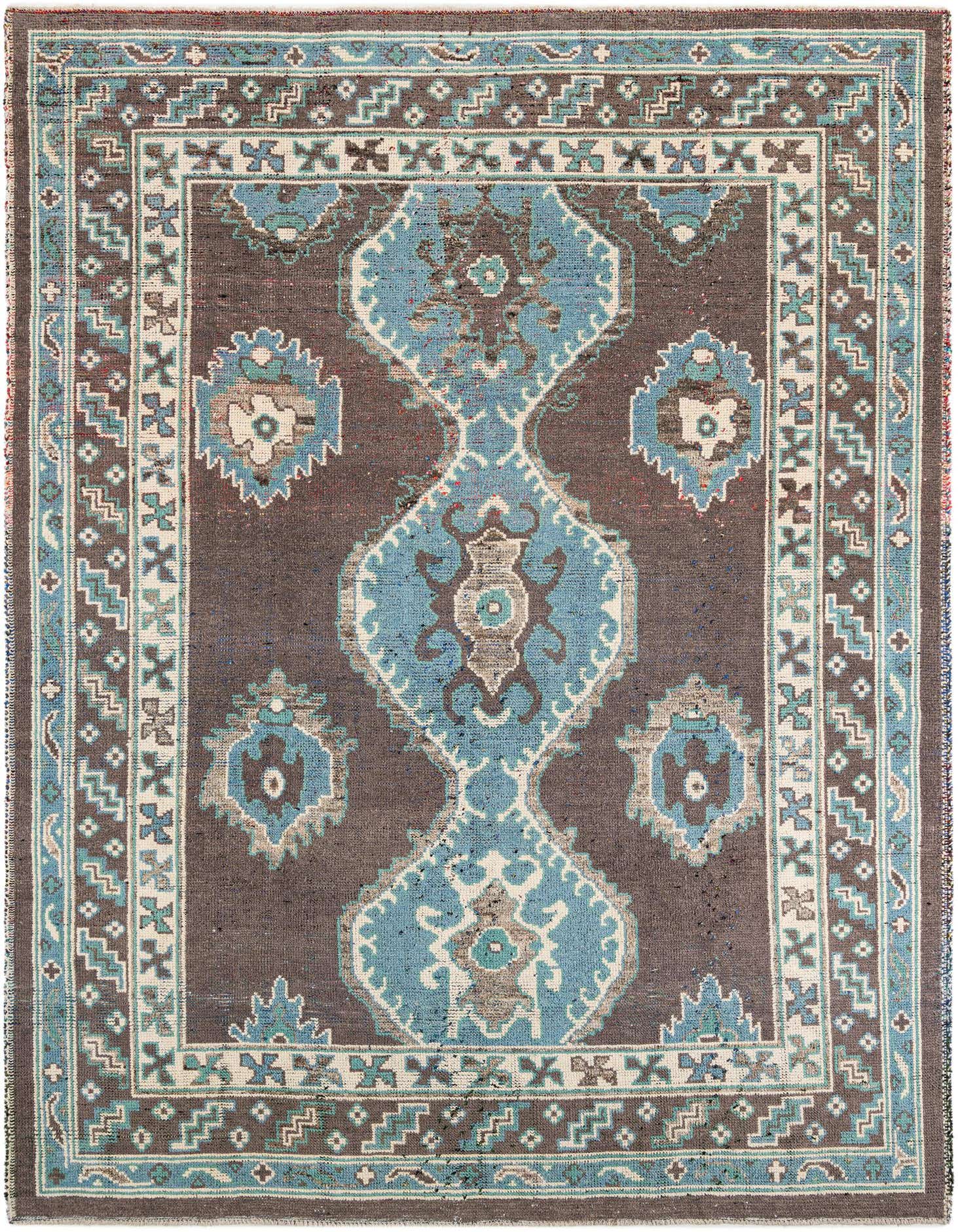 A 9x12 rectangular gray wool shag rug with a blue and white tribal medallion pattern, ideal for a living room.