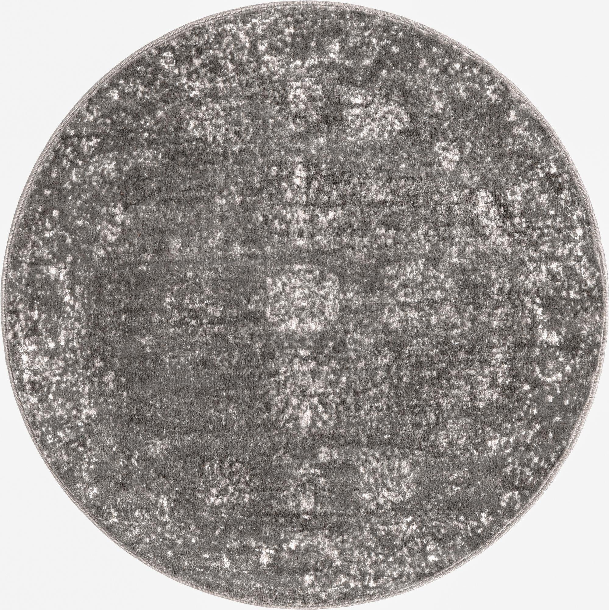 A 4' round gray area rug with a distressed, abstract medallion pattern, suitable for various indoor spaces.