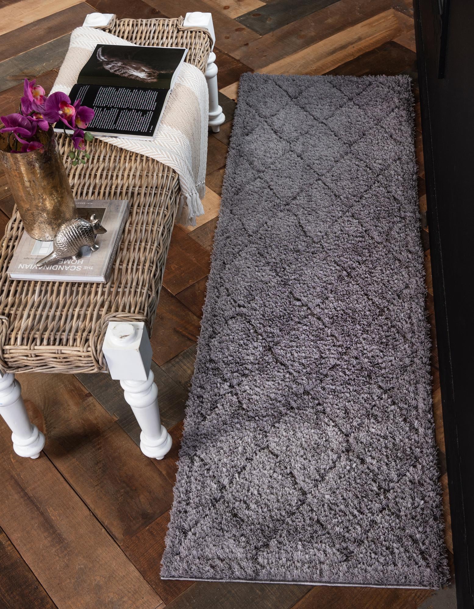 A 7 ft runner rug in a solid gray color with a textured high/low shag pile, perfect for hallways.