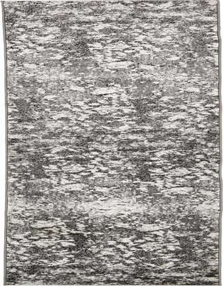 A 13 ft runner rug in shades of gray and silver with a distressed, abstract pattern, ideal for a hallway.