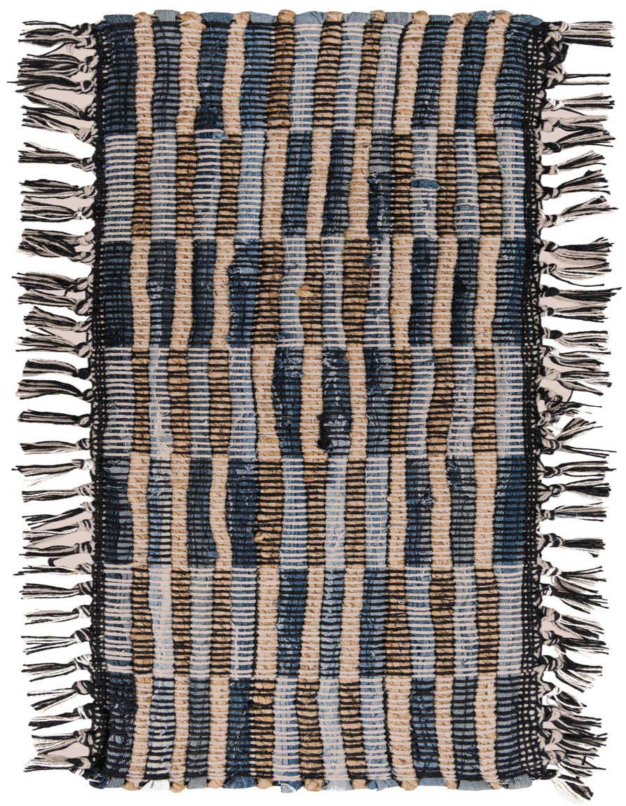 A gray and silver Chindi Jute stair rug with a modern abstract pattern and black and white tassels.