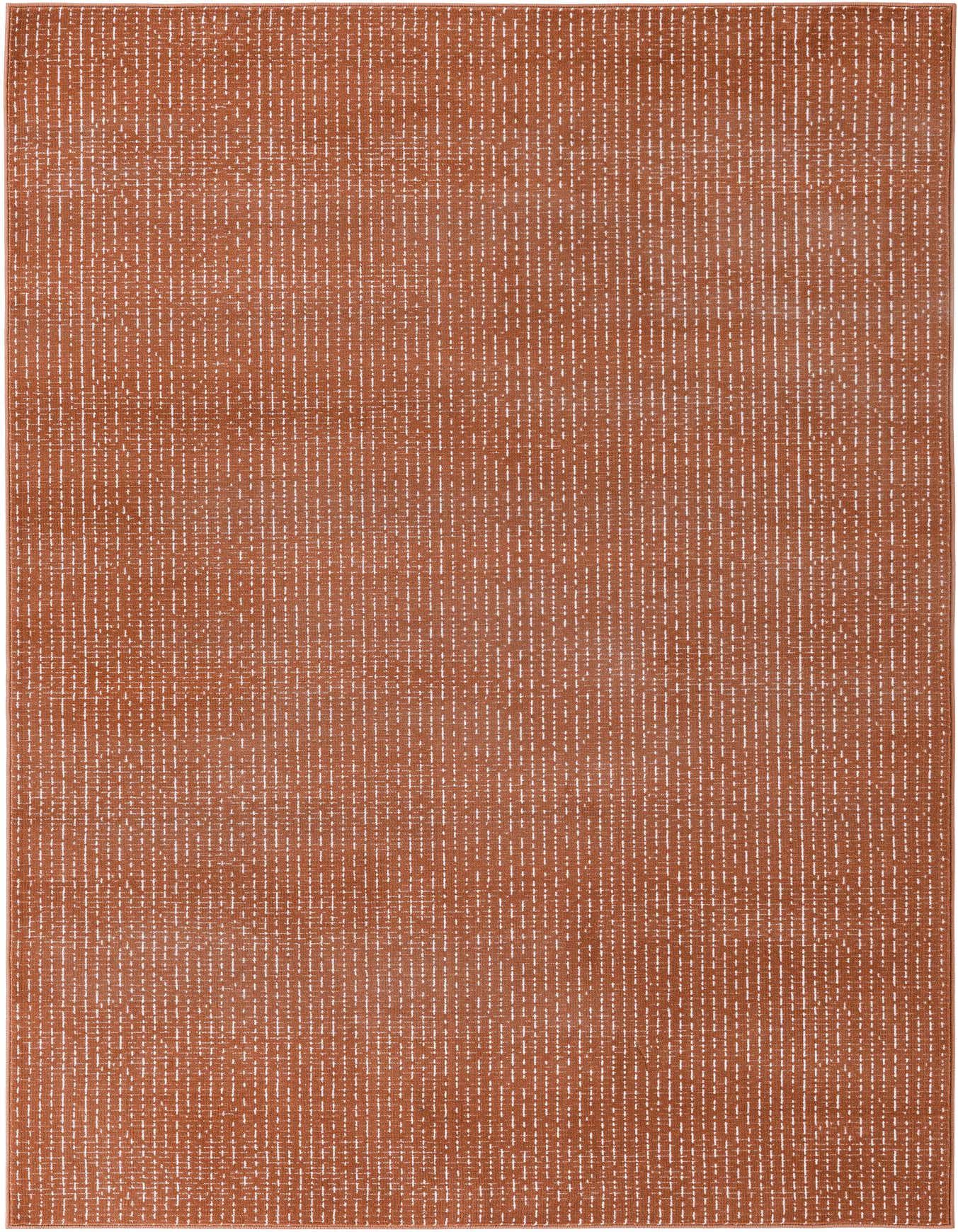 A 5x8 rectangular rug in a warm terracotta pink, featuring a subtle textured pattern of short, thin white dashes.