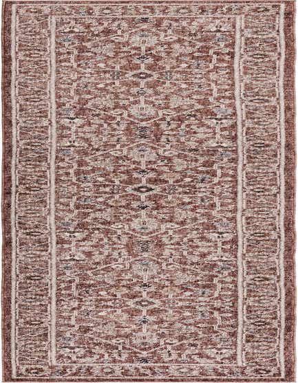 A 12 ft runner rug in shades of pink, featuring a distressed traditional oriental pattern with a modern trellis design.