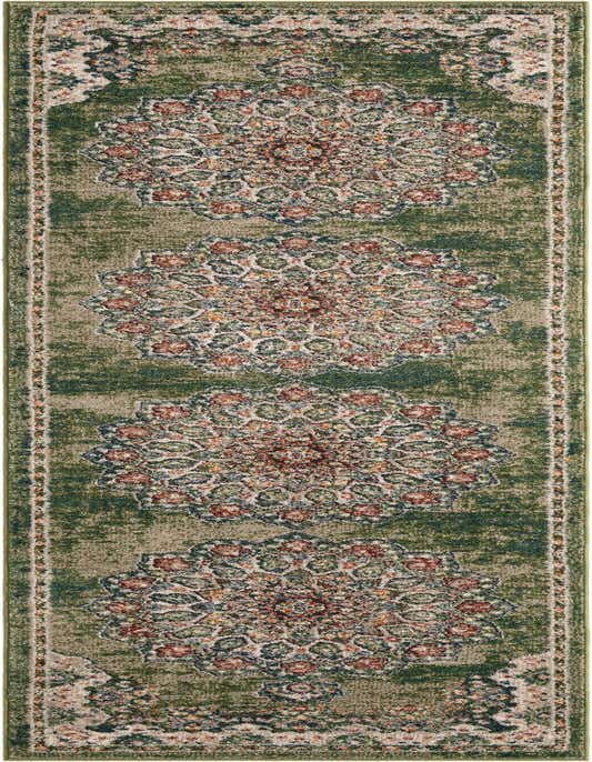 A 10 ft runner rug in shades of green with an ornate, distressed floral medallion pattern in red, blue, and cream.