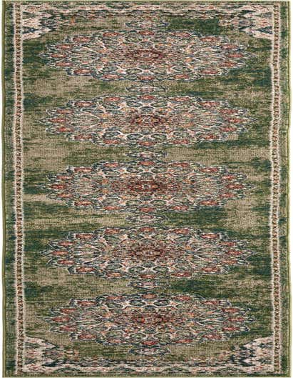A 13 ft runner rug in shades of green with an ornate, distressed traditional pattern featuring medallions in cream, rust, and blue.