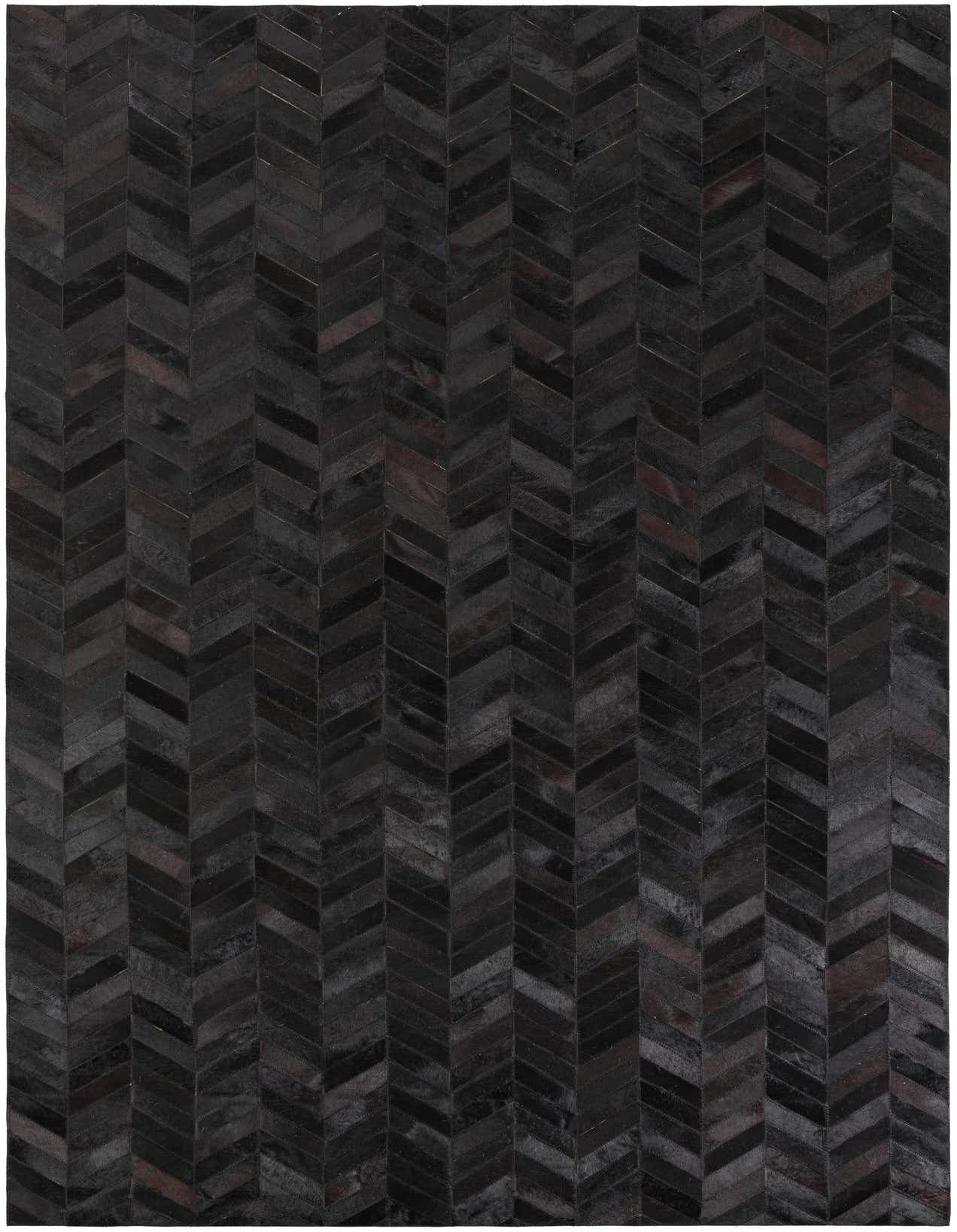 A 5x8 rectangular indoor rug featuring a modern chevron pattern made from varying shades of gray cowhide and leather.