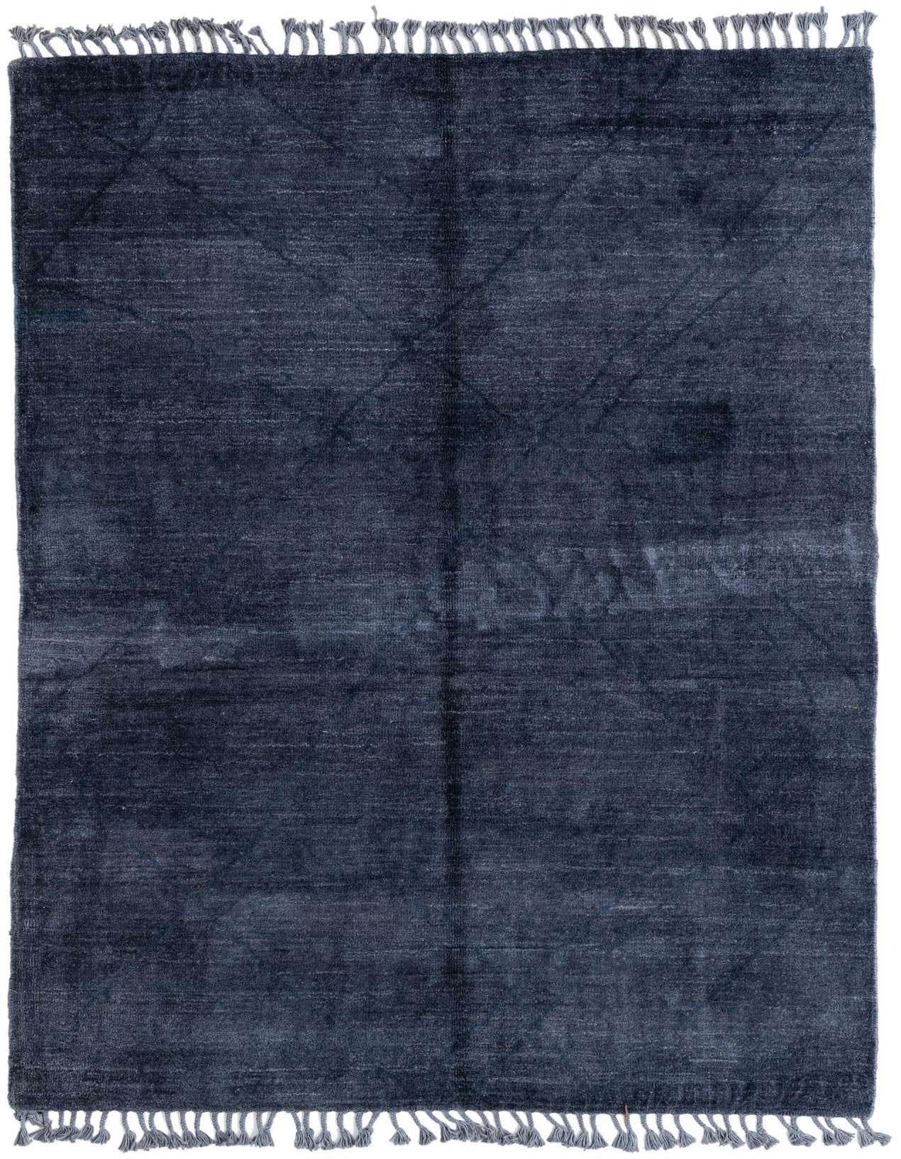 A rectangular 6x9 gray tribal shag rug with subtle abstract patterns and fringed edges, perfect for a living room.