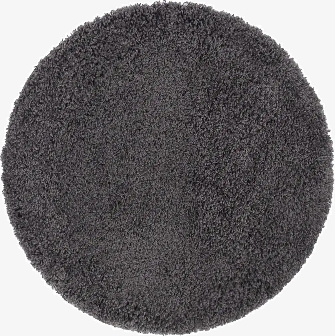 A 3' 0 x 3' 0 round gray shag rug with a textured, plush pile, suitable for modern indoor spaces.