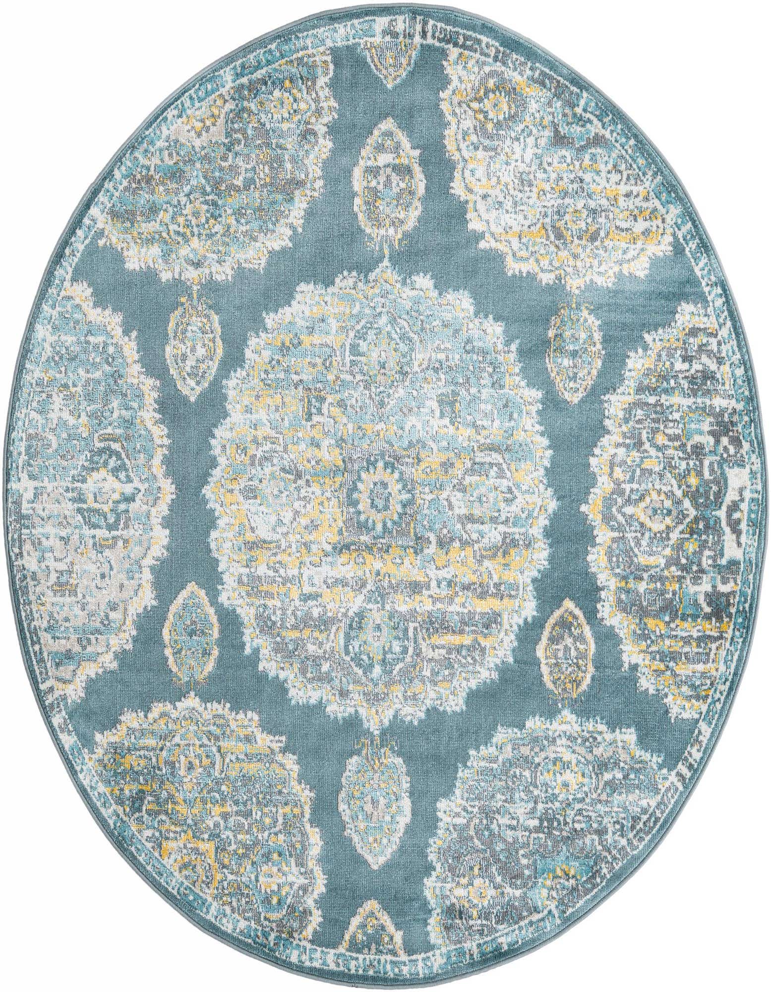 A 5' 5 round blue rug with a distressed Bohemian floral pattern in shades of yellow, light blue, and grey.