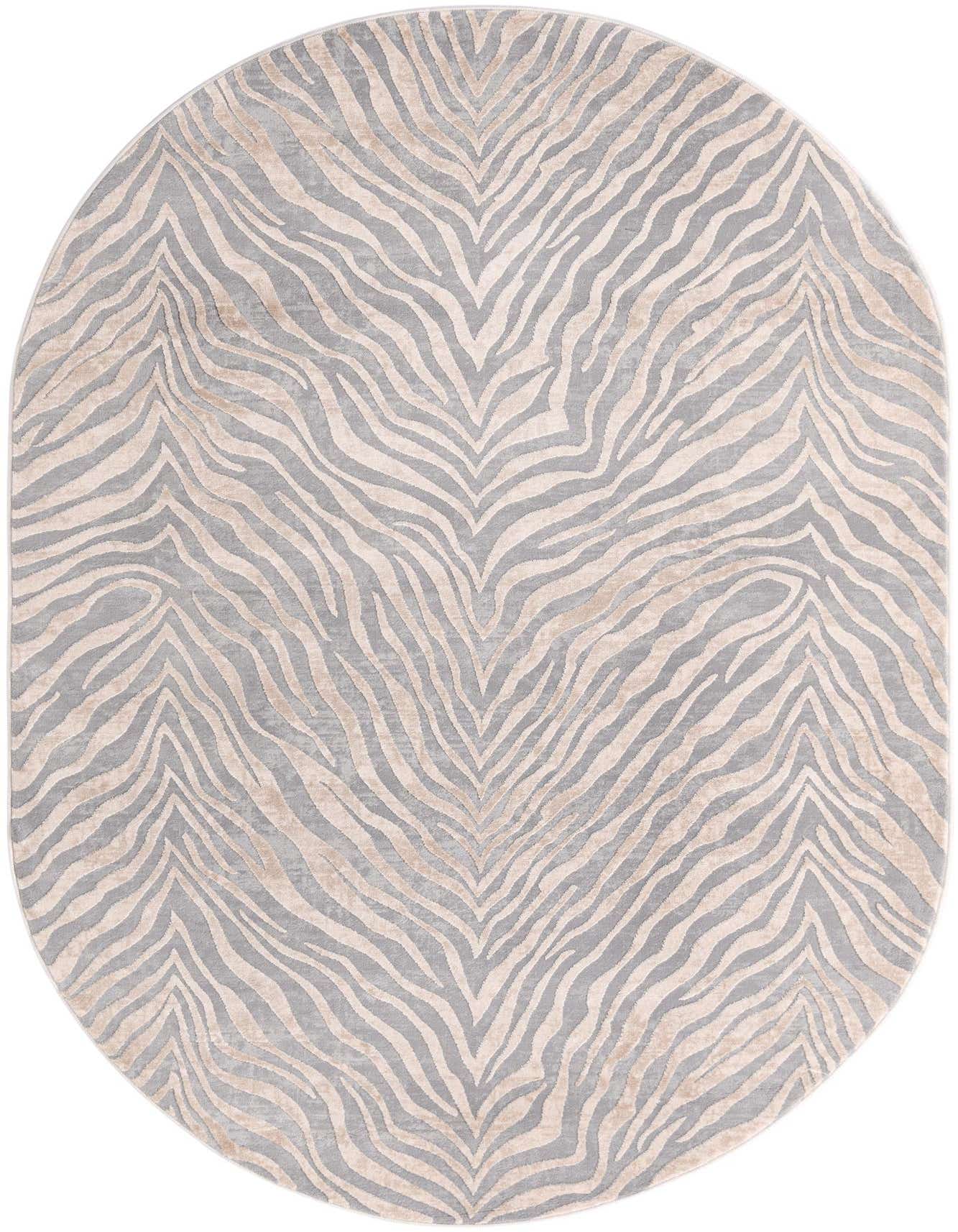 An oval 5' 3 x 8' 0 area rug with a modern stripe pattern in varying shades of ivory, cream, and gray, featuring a high/low textured pile.