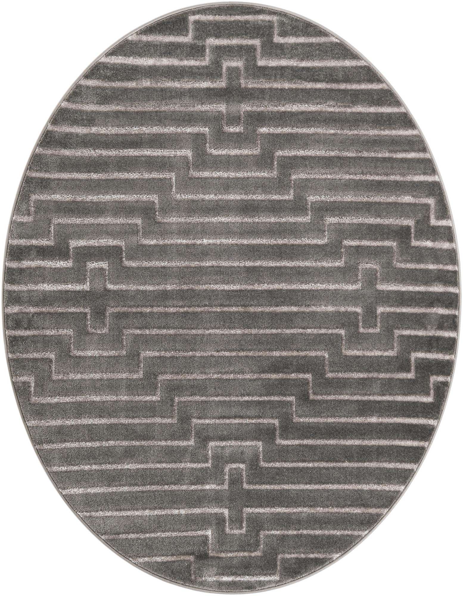 A round gray and silver rug with a textured geometric pattern, featuring horizontal lines and interlocking L-shapes.
